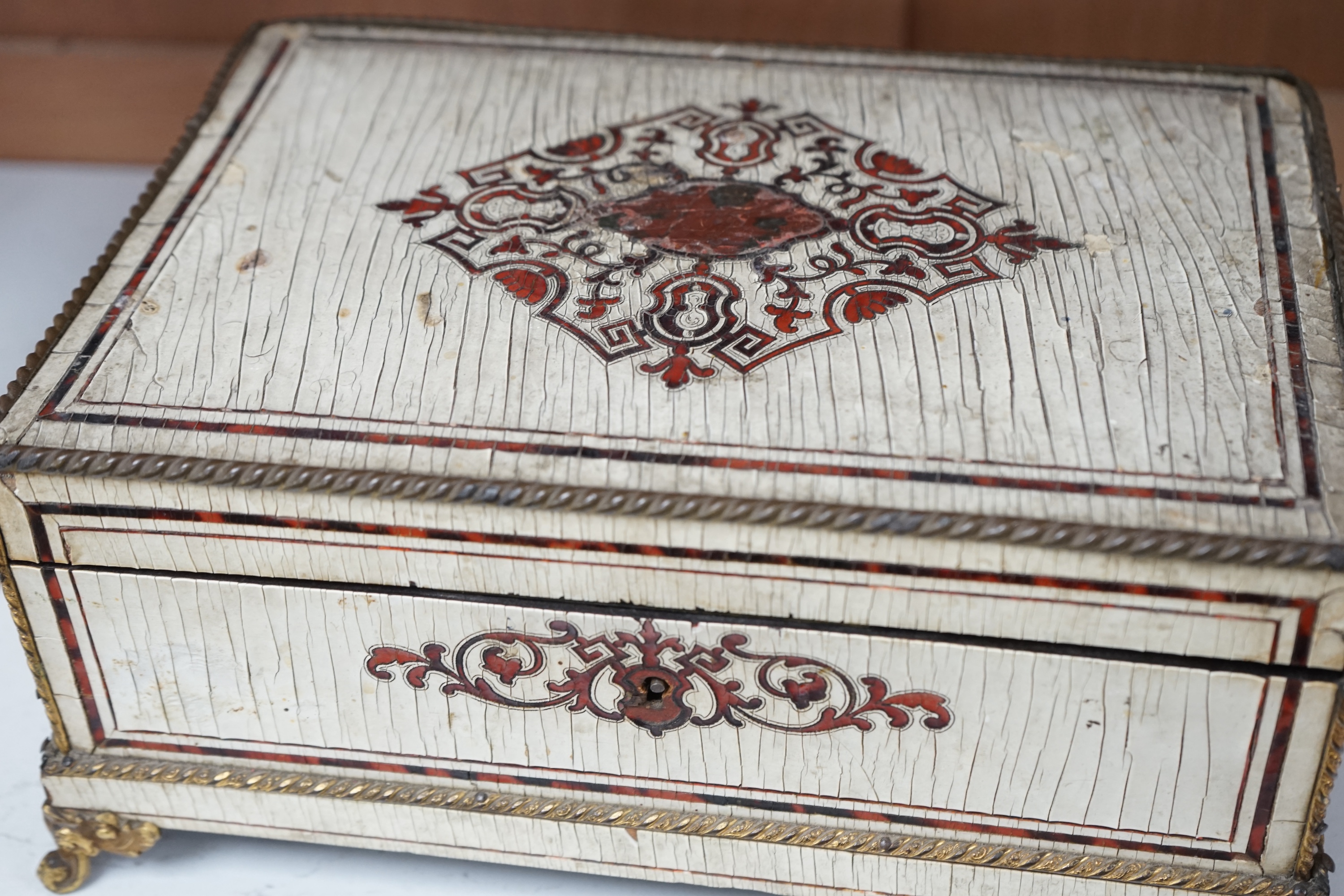 A 19th-century French tortoiseshell and faux lacquer work box, 24.5cm wide x 11.5cm high. Condition - poor to fair